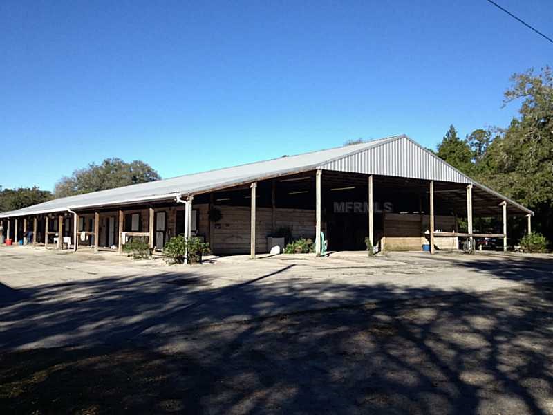 Horse Farm For Sale with 49 stalls, arena, and Cedar Home near Deland, FL - $495,000