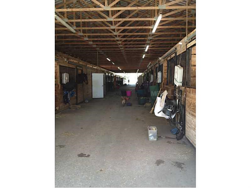 Horse Farm For Sale with 49 stalls, arena, and Cedar Home near Deland, FL - $495,000